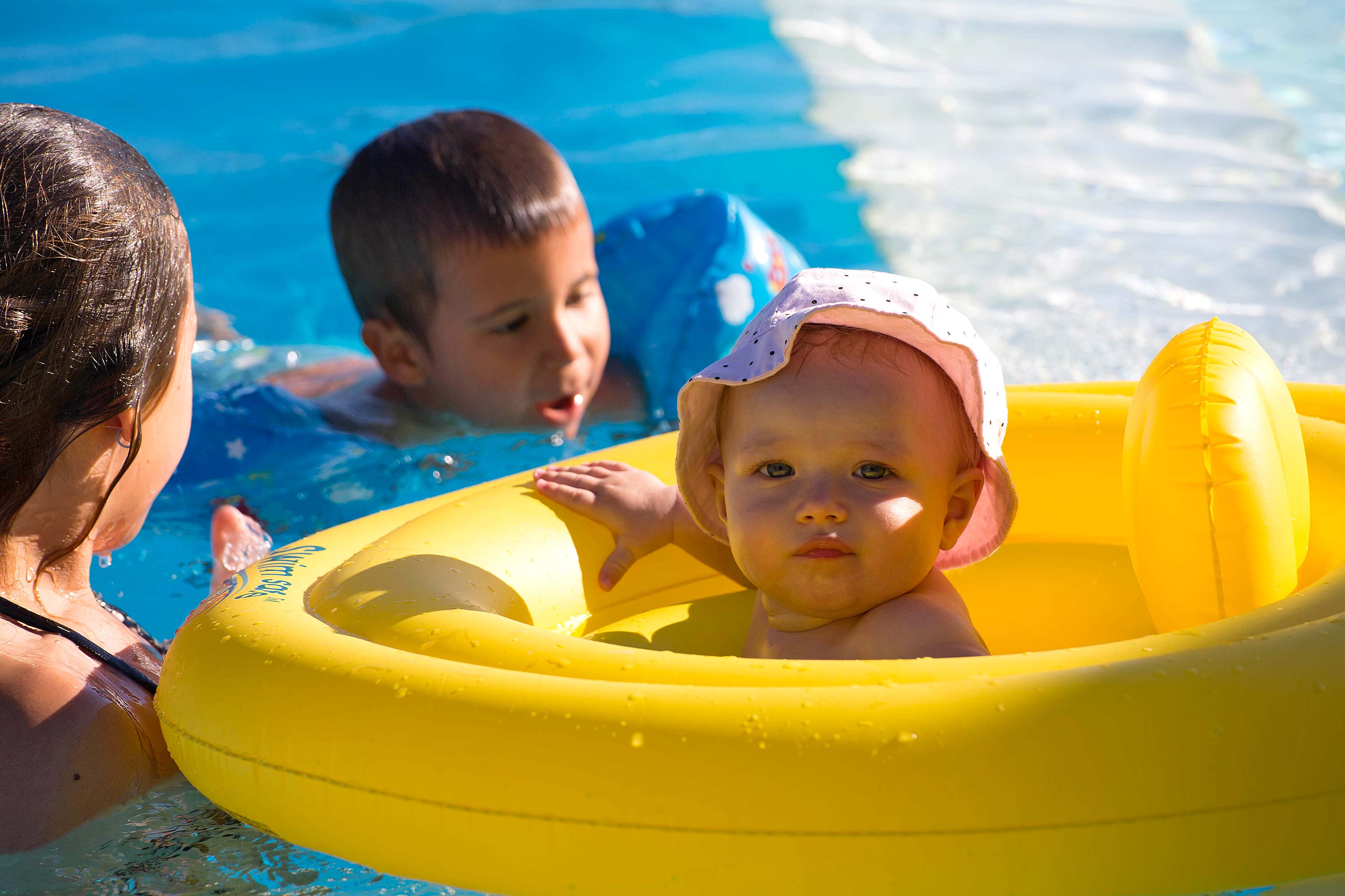 Kinder im Schwimmbad des Bauernhauses in der Toskana